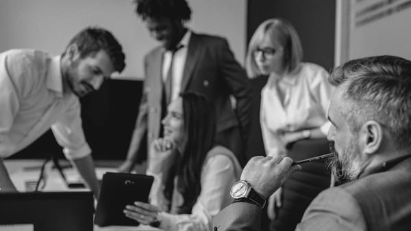 Executives and co-workers discuss work health and safety (WHS) updates at work.