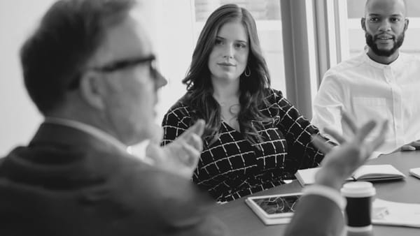Workplace meeting where manager and employees are discussing what WorkCover is in Australia.