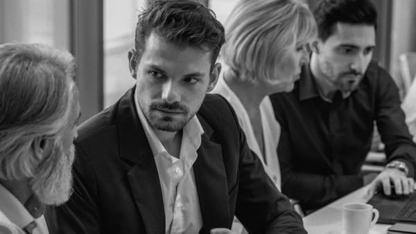 Executives and co-workers discuss work health and safety (WHS) updates at work.